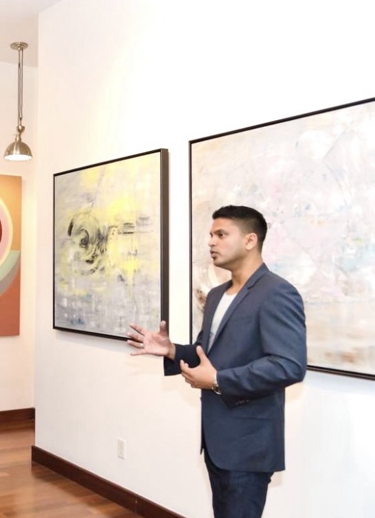 Anand speaking in a gallery setting